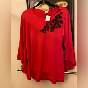 Red top with black appliqué and bell sleeves.  Size Med- NWT